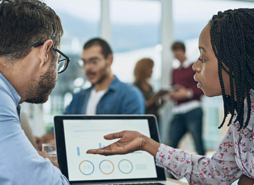 a man and a women discussing their charity data analysis